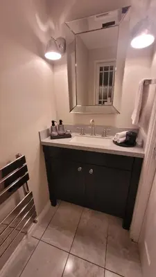 a bathroom with a sink and a mirror at Stylish, Modern 3 bedroom house, free parking x 2 in Mansewood
