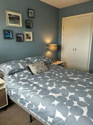 a bedroom with a large bed in a room at The Beach View - Greenan in Ayr
