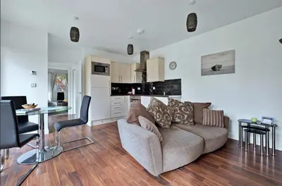 a living room with a couch and a table at Turbine House in Lochgilphead