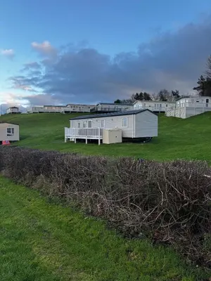 a group of white mobile homes in a field at Arran View Caravan in Ayr