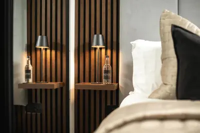 a bedroom with two bottles on night stands next to a bed at South Lane Apartments - City Centre in Edinburgh