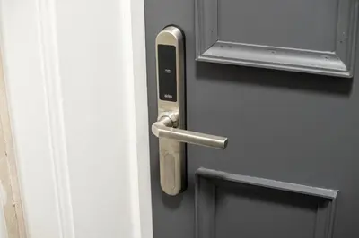 a door with a handle on a door at South Lane Apartments - City Centre in Edinburgh