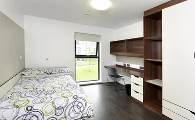 a bedroom with a bed and a desk at Alexander Court Townhouse in Stirling