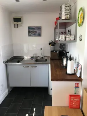 a kitchen with a sink and a counter top at Pier Cottage at Kames in Kames
