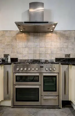 a kitchen with a stainless steel stove and a hood at Stirling Edwardian House - Fireplace,Garden,Parking in Stirling