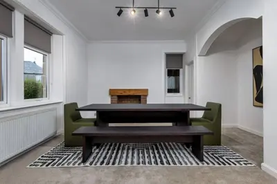 a dining room with a table and green chairs at Stirling Edwardian House - Fireplace,Garden,Parking in Stirling