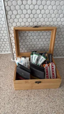 a wooden box filled with books on the floor at Stylish Clyde Riverfront Flat with Balcony Views in Glasgow