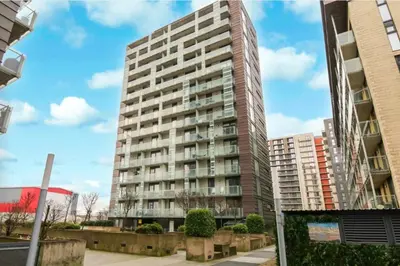 a tall apartment building on a city street at Stylish Clyde Riverfront Flat with Balcony Views in Glasgow