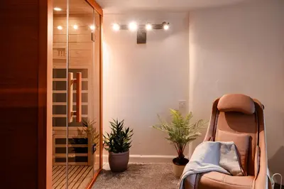 a room with a chair and potted plants at Fir Tree Lodge - Seasgair Lodges in Crieff