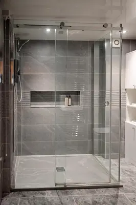 a shower with a glass door in a bathroom at Fir Tree Lodge - Seasgair Lodges in Crieff