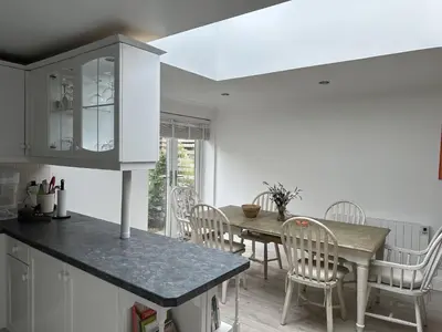 a kitchen and dining room with a table and chairs at Mid- Village Croft in Cairndow