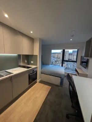a room with a bed and a kitchen with a view at For Students Only West End in Glasgow in Glasgow