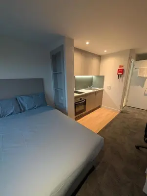a bedroom with a large bed and a sink at For Students Only West End in Glasgow in Glasgow