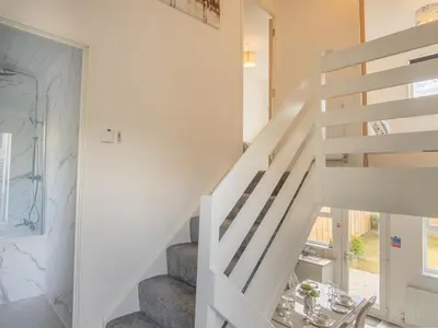 a staircase in a home with a white stair case at Etive House - 3 bedroom stylish home in Cumbernauld