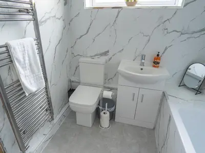 a white bathroom with a toilet and a sink at Etive House - 3 bedroom stylish home in Cumbernauld