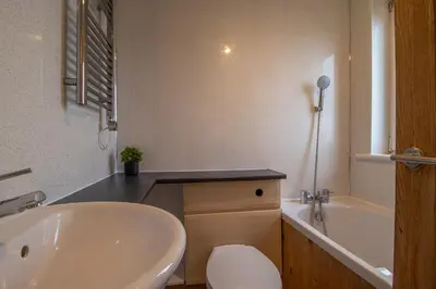 a bathroom with a sink and a tub and a toilet at Lynwood - 4 Bedroom House with Views of Loch Gilp in Ardrishaig