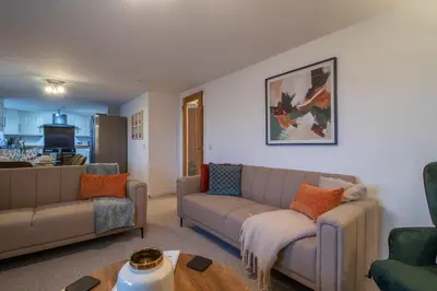 a living room with a couch and a table at Lynwood - 4 Bedroom House with Views of Loch Gilp in Ardrishaig