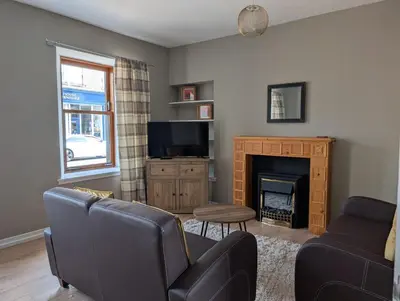 a living room with a couch and a fireplace at Argyll Place in Campbeltown