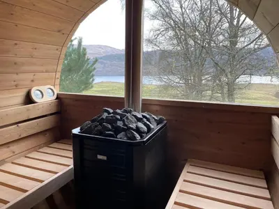 a sauna with a window and a trash can at Coach House at Morenish Mews in Killin