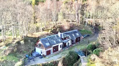 an aerial view of a house in the woods at Coach House at Morenish Mews in Killin