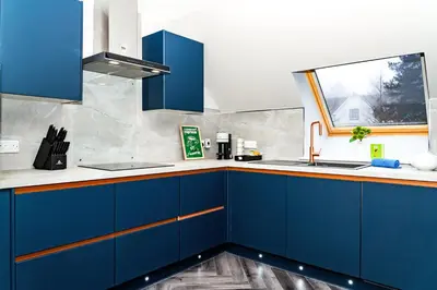 a kitchen with blue cabinets and a window at Gleneagles Hideaway