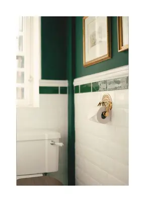 a bathroom with a toilet and a green wall at Historic Hideaway - Dean Village in Edinburgh