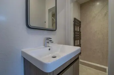 a bathroom with a white sink and a mirror at Raeburn House- 3 Bedrooms, 2 Bathrooms in Hamilton in High Blantyre