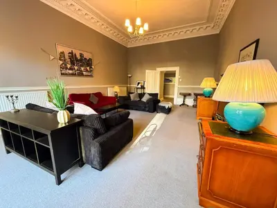 a living room with a couch and a table at Spacious Three Storey West End Home - 3 bedroom in Glasgow