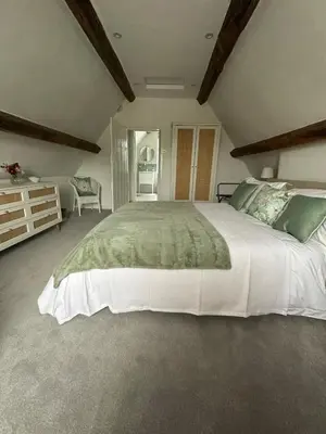 a large bedroom with a large white bed in a room at Charming Cotswold stone cottage with garden in Moffat