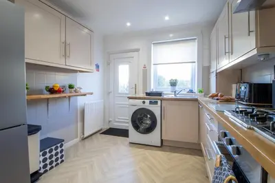 a kitchen with a washing machine in the middle at The Bridge- 3 Bedrooms in Coatbridge with Driveway in Moffat