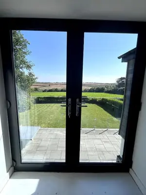 a window in a room with a view of a lake at Tranquil Countryside Escape in Moffat