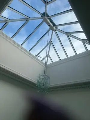 a glass ceiling with a chandelier in a room at Murrayfield Executive Apartment in Edinburgh