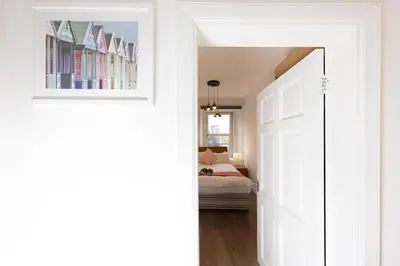 a hallway with a door leading to a bedroom at Central Cosy Apartment by Meadows 6 in Edinburgh