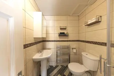 a bathroom with a toilet and a sink at Central Cosy Apartment by Meadows 6 in Edinburgh