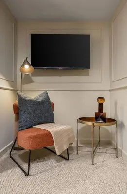 a living room with a chair and a table at The Bruces Quarter in Stirling