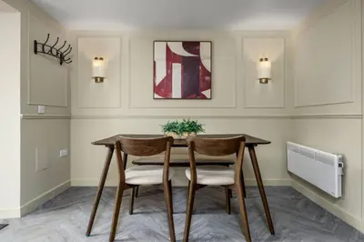 a dining room with a table and two chairs at The Bruces Quarter in Stirling