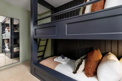 a blue bunk bed with pillows on it in a room at The Bruces Quarter in Stirling