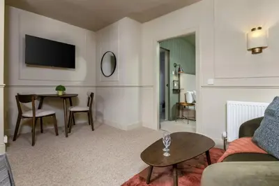 a living room with a couch and a table at The Braveheart Suite by The Wallace Monument in Stirling