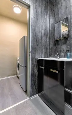 a bathroom with a sink and a refrigerator at The Braveheart Suite by The Wallace Monument in Stirling