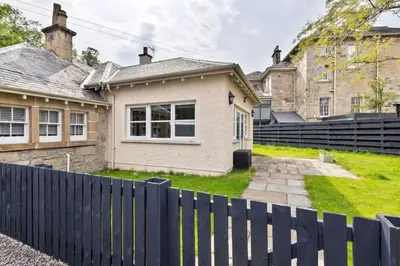 a house with a black fence in front of it at Kings Park Garden Cottage - Free Parking in Stirling