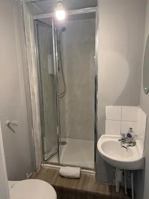 a bathroom with a shower and a sink and a toilet at West End Stay by Kelvingrove in Glasgow