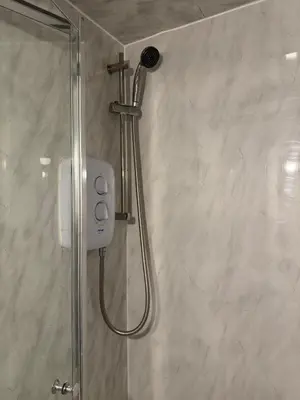 a shower with a shower head in a bathroom at West End Stay by Kelvingrove in Glasgow