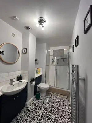 a bathroom with a sink toilet and a shower at Duplex Penthouse with Secured Parking Finnieston in Glasgow