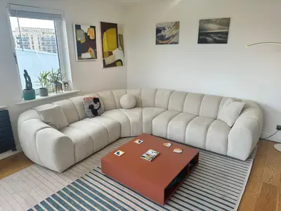 a living room with a white couch and a coffee table at Duplex Penthouse with Secured Parking Finnieston in Glasgow