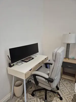an office with a desk with a computer monitor and a chair at Modern & Cozy Apartment in the Heart of the City in Moffat