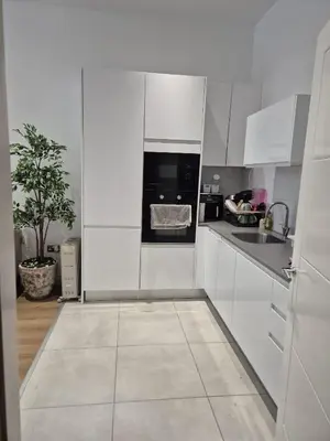 a white kitchen with a sink and a stove at Modern & Cozy Apartment in the Heart of the City in Moffat