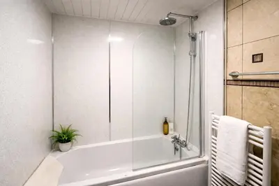 a bathroom with a shower and a bath tub at Contractors and Guests Grand 3 Bedroom Central Free Parking Fully equipped in Glasgow