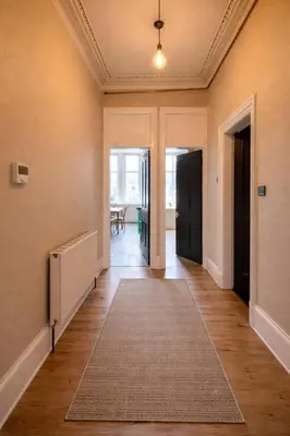 an empty hallway with a rug on the floor at Contractors and Guests Grand 3 Bedroom Central Free Parking Fully equipped in Glasgow