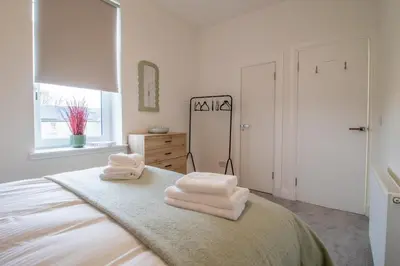 a bedroom with a bed with towels on it at William Wallace View - 5 Bedrooms in Stirling in Stirling
