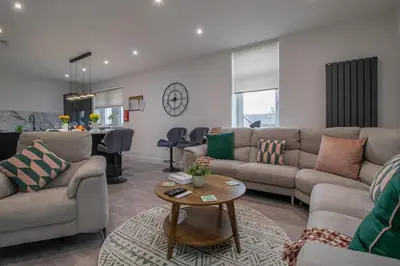 a living room with a couch and a table at William Wallace View - 5 Bedrooms in Stirling in Stirling